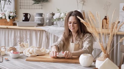 Woman Crafts with Clay at Kitchen Table