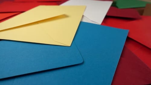 Falling multi-colored envelopes. Slow motion.
