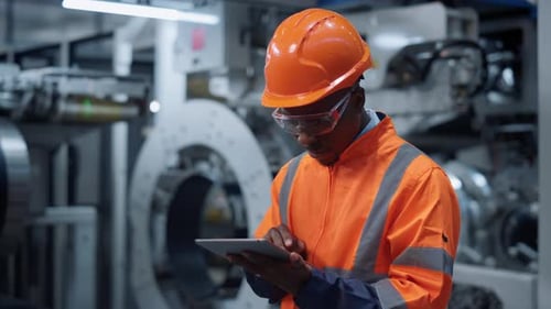 African American Professional Analyzing Logistics Work on Huge Modern Factory