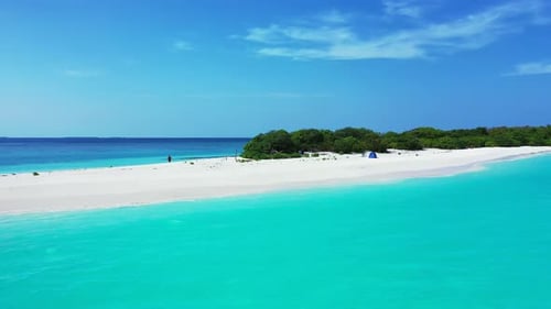 Wide overhead island view of a white sandy paradise beach and blue sea background in best quality 4K