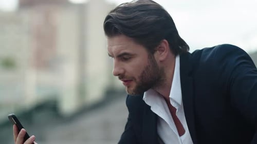 Businessman Having Video Chat on Smartphone. Male Employee Using Phone on Street