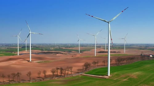Farms of wind turbines on the field near the road