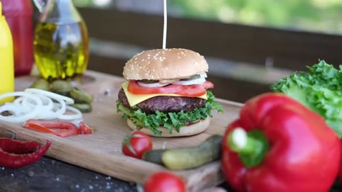 Delicious Burger With Fresh Ingredients on Wooden Board