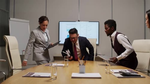 Professionals Meeting at Conference Table Discussing Business