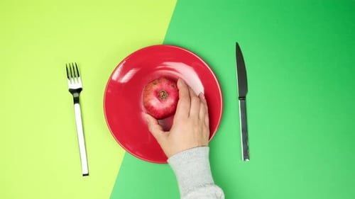 Preparing to Cut a Red Apple on Plate