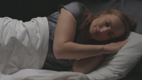 Woman Sleeping Peacefully in Bed at Night