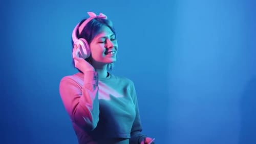 Stylish Woman Listening to Music with Headphones