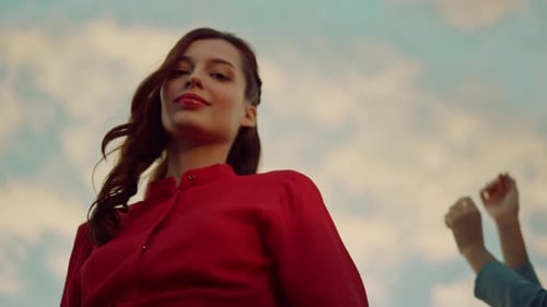 Happy Young Woman Dancing with Friends Outside