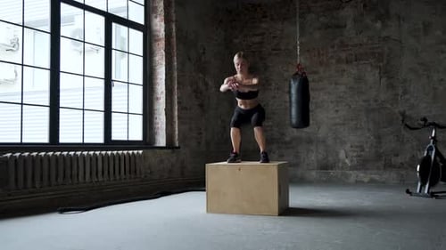 Young Female Athlete Doing A Box Jump At The Gym
