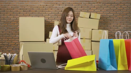 Woman Packing Merchandise in Colorful Shopping Bags
