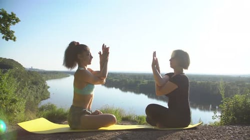 Women Practicing Yoga Outdoors in Daylight