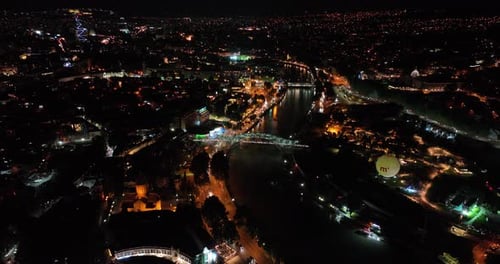 Night aerial view of Bridge of Peace and beautiful cityscape in the center of Tbilisi, Georgia 2022