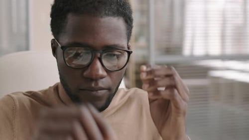 Young Adult Puts on Glasses and Headset