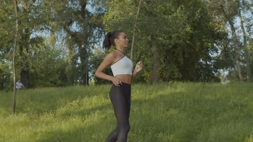 Black Female Jogger Running in Public Park at Dawn