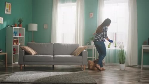 Woman Cleans House, Sprays Indoor Plant
