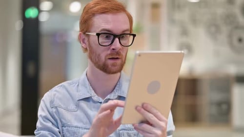 Young Adult Celebrating Good News on Tablet