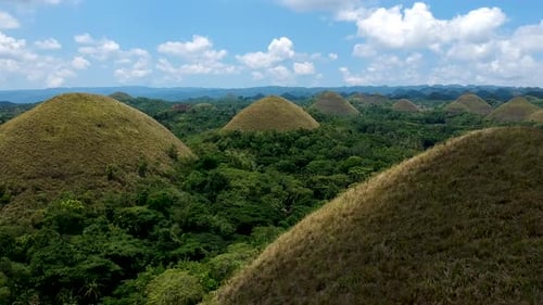 Low flying aerial in chocolate hills. Chocolate Hills viewing complex, Bohol, Philippines