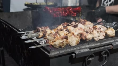 Shish Kebab and Mushrooms on Skewers Cooked on Barbecue at Street Food Festival