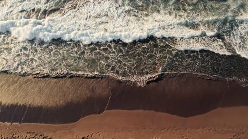 Aerial View of Waves Crushing on Beach