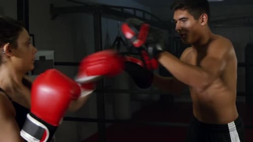 Woman Training Boxing with a Shirtless Trainer