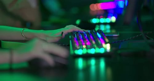 Competitive Gamers Typing on Colorful Illuminated Keyboards