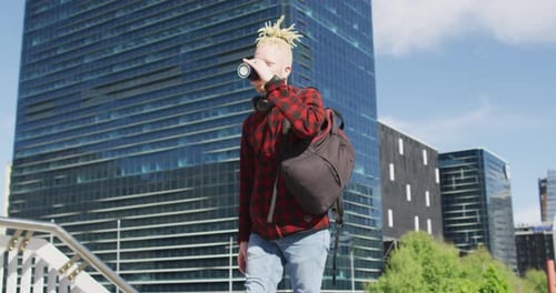 Young Adult Walking and Drinking in the City