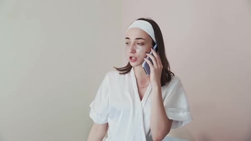 Woman in Robe Talks on Cell Phone
