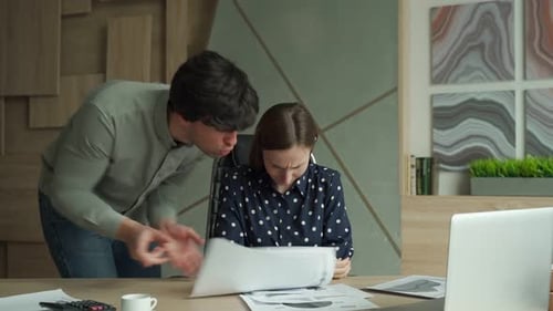 Man Arguing with Woman at Office Desk