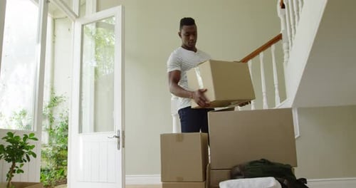 Man Moving Boxes Into New House