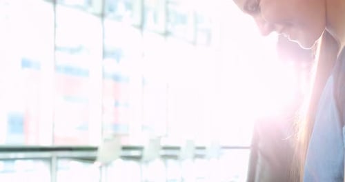 Woman Using Smartphone in Bright Urban Setting