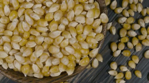 Bowl of Dried Corn Kernels on Wooden Table