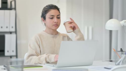 Woman Working At Laptop Drinking Coffee