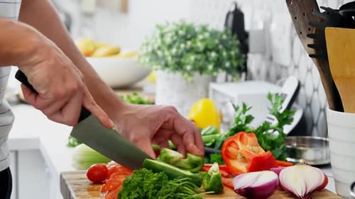 Man cutting vegetables in kitchen at home 4k