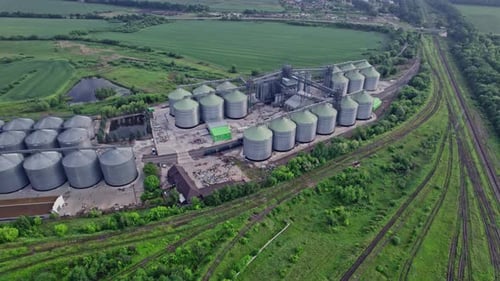 Commercial Grain Or Seed Silos In Sunny Spring Rural Landscape