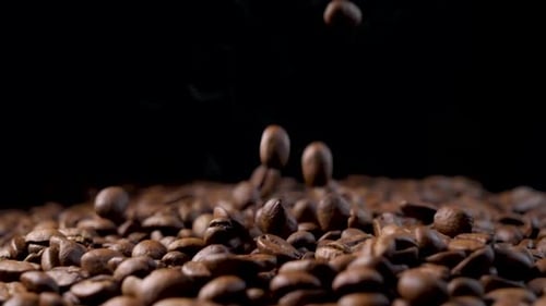 Coffee Beans Falling with Smoke on Black Background