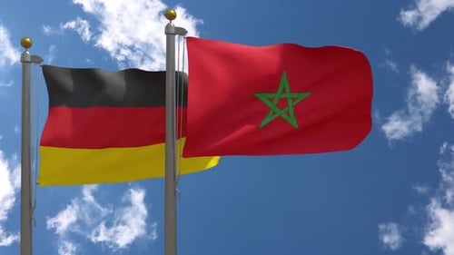 Germany and Morocco Flags Waving on Clear Sky