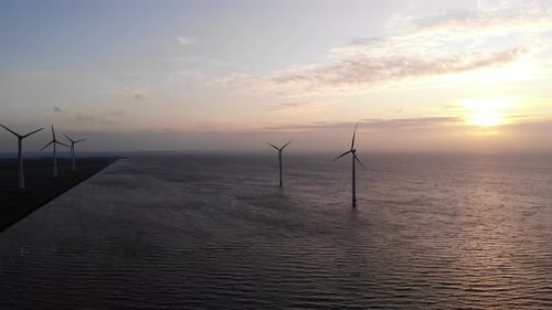 Offshore Windmill Park with Clouds and a Blue Sky Windmill Park in the Ocean Drone Aerial View with