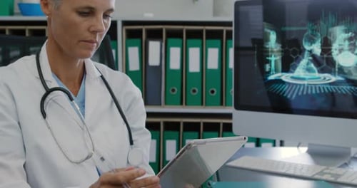 Doctor Working with Tablet and Computer in Office