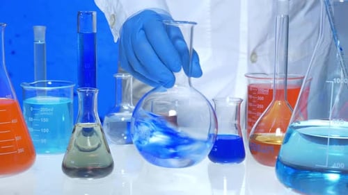 Adding Blue Liquid to Flask in Laboratory Setting