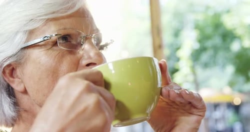 Senior woman drinking coffee 4k
