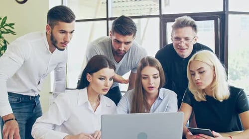 Office Team Collaborates Looking at Laptop