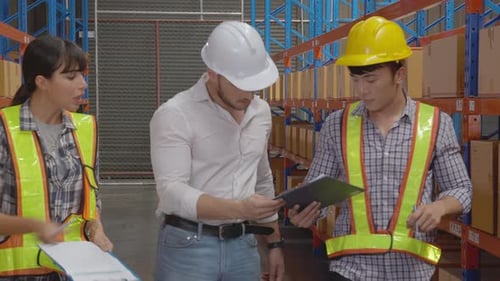 Warehouse Workers Discussing Inventory and Logistics