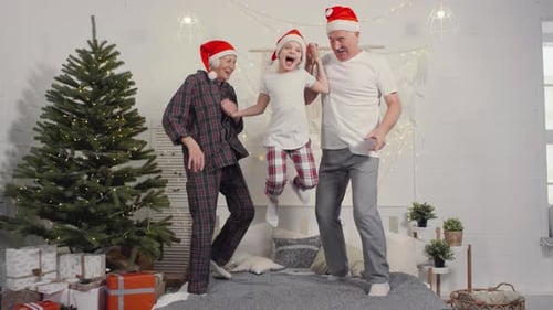 Family Fun: Grandparents and Child Jumping on Bed