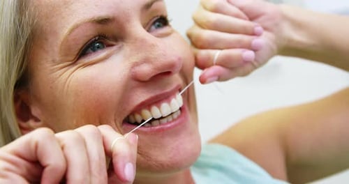 Woman flossing her teeth