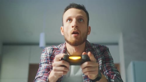 Man Playing Video Games, Winning with Excitement