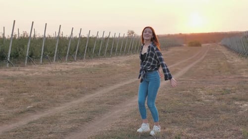 Redhead Woman Having a Fun at Sunset