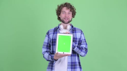 Young Adult Presenting Tablet with Green Screen