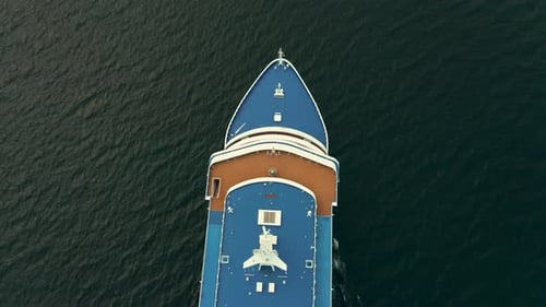 Gorgeous Aerial View of a Beautiful White Cruise Ship Heading Into Open Waters