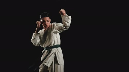 Woman Practicing Karate Techniques in a Studio