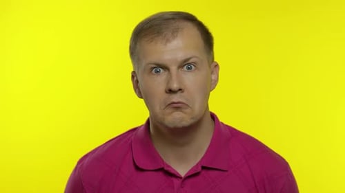 Man Glancing, Staring Against Bright Yellow Background